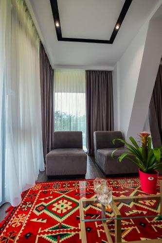 a living room with a couch and a table at Hotel Uji Ftohte Tepelene in Tepelenë