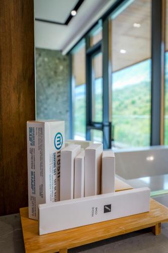 a bunch of books sitting on a wooden table at Hotel Uji Ftohte Tepelene in Tepelenë
