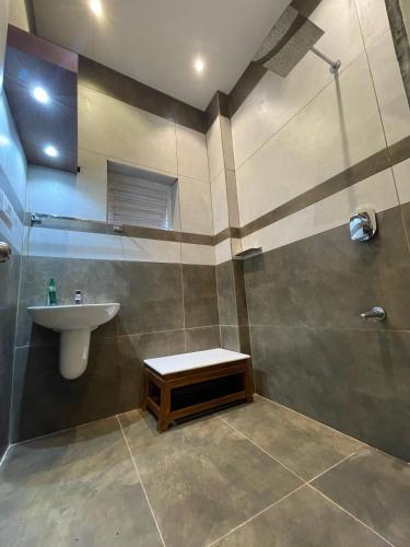 a bathroom with a sink and a shower at Softouch Ayurveda Village Kerala in Kizhake Chālakudi