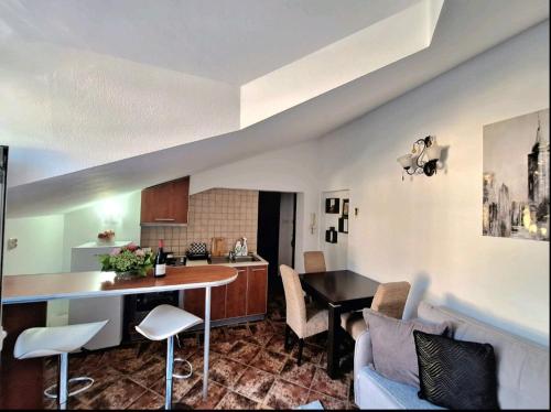 a kitchen and living room with a table and chairs at Rose Apartment in Kotor