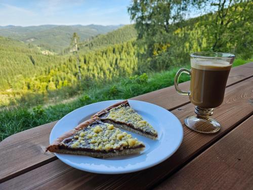 a plate with a slice of bread and a cup of coffee at Chalupa Štrčková - srdce Valašska in Vsetín