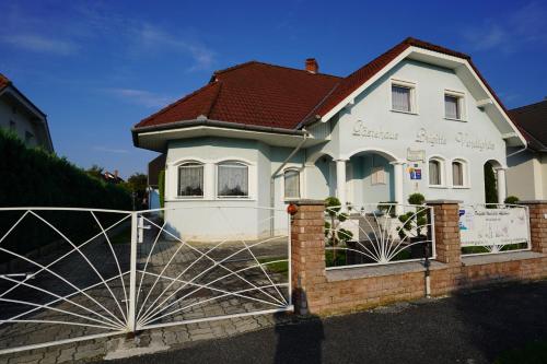 a house with a gate in front of it at Apartman Brigitte Bükfürdő in Bük