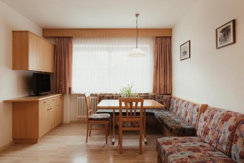 a living room with a table and a couch at Residence Costa Burjada in Colfosco