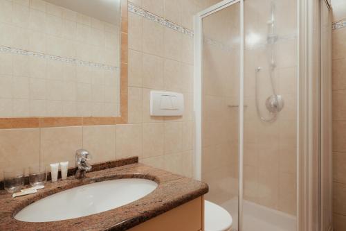 a bathroom with a sink and a shower at Residence Costa Burjada in Colfosco