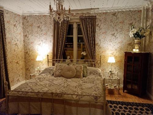 1 dormitorio con 1 cama en una habitación con papel pintado en Wedbergs Rum, en Säffle