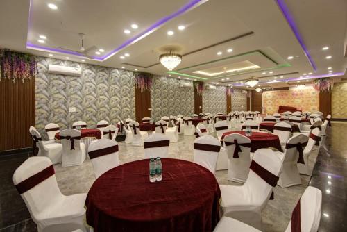 um salão de banquetes com mesas e cadeiras numa sala em Hotel La Mirage em Noida