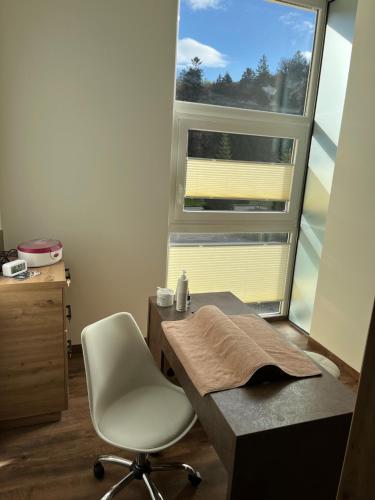 a room with a desk and a chair and a window at Morada Hotel Alexisbad in Alexisbad