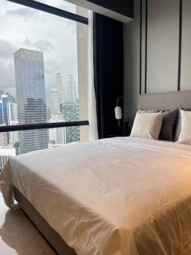 a bedroom with a large bed and a large window at AXON APARTMENT RESIDENTIAL SUITE in Kuala Lumpur