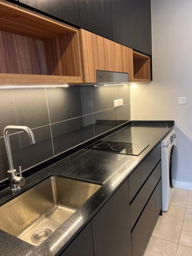 a kitchen with a sink and a stainless steel counter top at AXON APARTMENT RESIDENTIAL SUITE in Kuala Lumpur