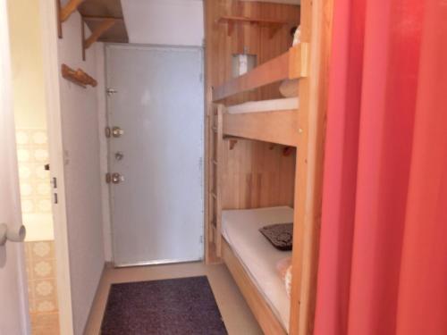 a small room with a bunk bed and a closet at Studio au cœur du Sauze - La grande Chaume in Enchastrayes