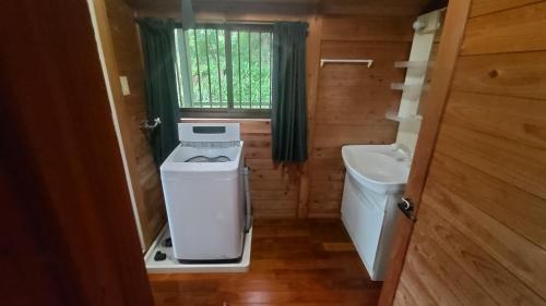 a small bathroom with a washing machine and a sink at Whole house rental inn Horizon line - Vacation STAY 18087v in Yakushima