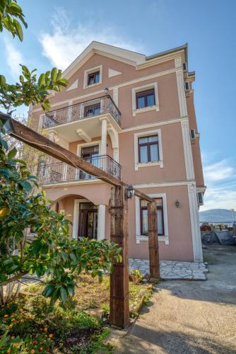 a large pink house with balconies on top of it at Tivat Star in Tivat