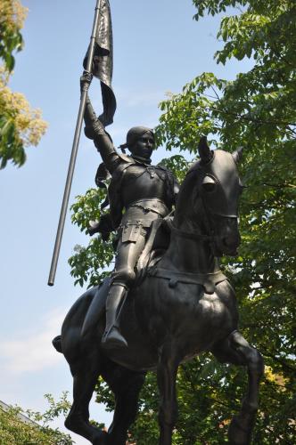 a statue of a man on a horse holding a flag at Hotel Foch Nancy Gare in Nancy