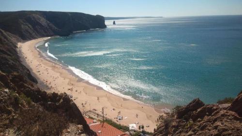 a group of people on a beach near the ocean at Ocean Suite - Villa Luar in Aljezur