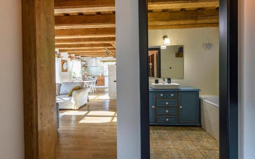 a bathroom with a blue cabinet and a living room at Drevenica Spiaci Goral in Ždiar