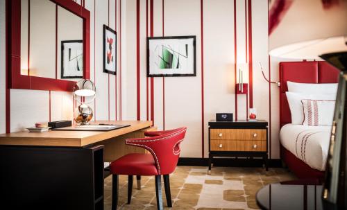 a bedroom with a desk and a bed and a desk at Dinamo Hotel Baku in Baku