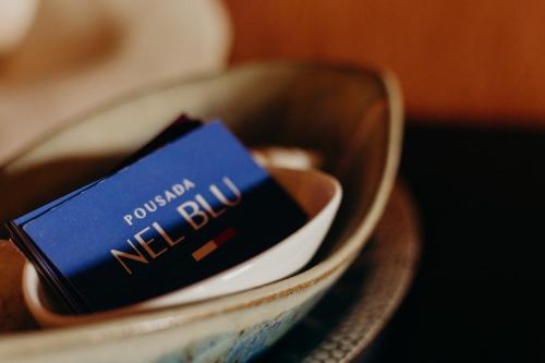 a blue book is sitting in a bowl at Pousada Nel Blu in Itaparica