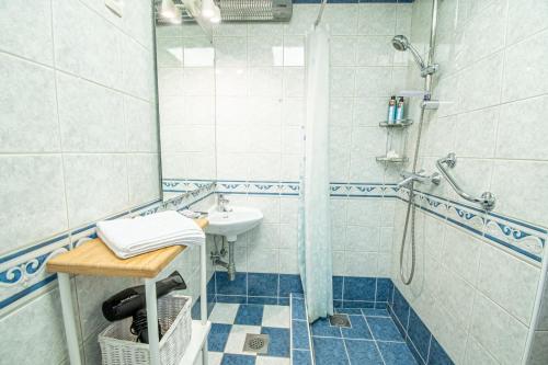 a bathroom with a sink and a shower at Umag center apartment parking by Rentistra in Umag