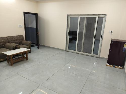 a living room with a couch and a table at Shiv Shakti Homestay in Ujjain