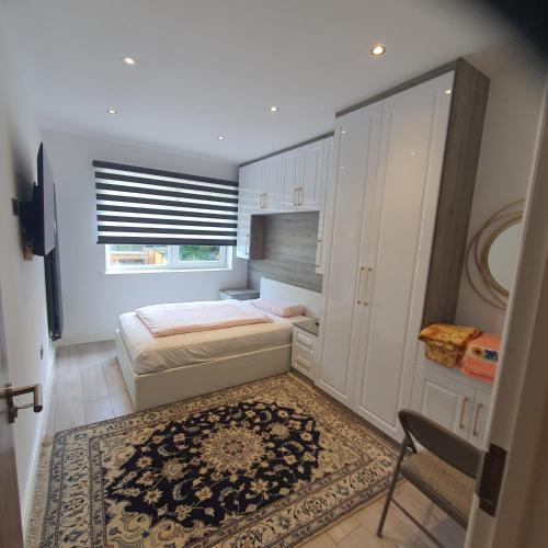 a small bedroom with a bed and a window at 64 Salmon Street in London