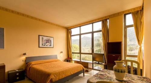 - une chambre avec un lit, une table et des fenêtres dans l'établissement Cleotto residence case vacanza, à Palerme