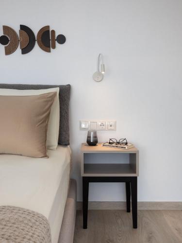 a bed with a night stand next to a side table at Mandilaras Village in Vívlos