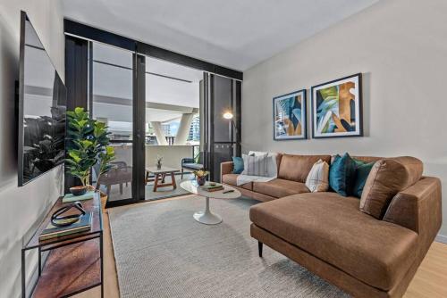 a living room with a couch and a table at South Bank Sensational! ~ 1Bed,1Bath,1Car,Balcony in Brisbane