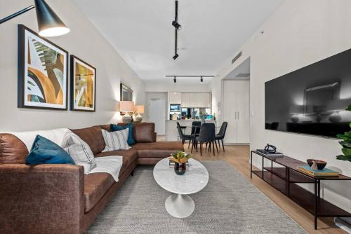 a living room with a couch and a table at South Bank Sensational! ~ 1Bed,1Bath,1Car,Balcony in Brisbane
