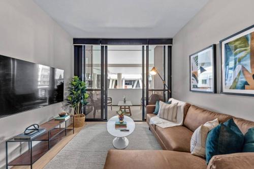 a living room with a couch and a table at South Bank Sensational! ~ 1Bed,1Bath,1Car,Balcony in Brisbane