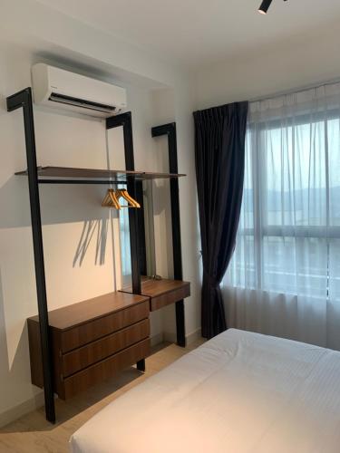 a bedroom with a bed and a dresser and a window at FHS Homestay @ Arte Plus Jalan Ampang T1-40-02 in Kuala Lumpur