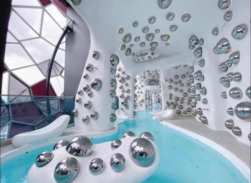 a room with a tub with a bunch of silver balls at FHS Homestay @ Arte Plus Jalan Ampang T1-40-02 in Kuala Lumpur
