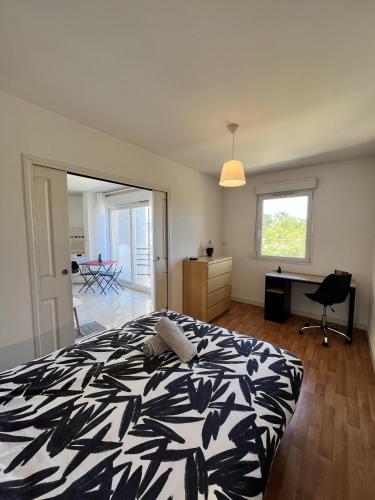 - une chambre avec un lit noir et blanc et un bureau dans l'établissement L'alienor - Parking - Hôpital - 2 Pers - Rêve au Mans, au Mans