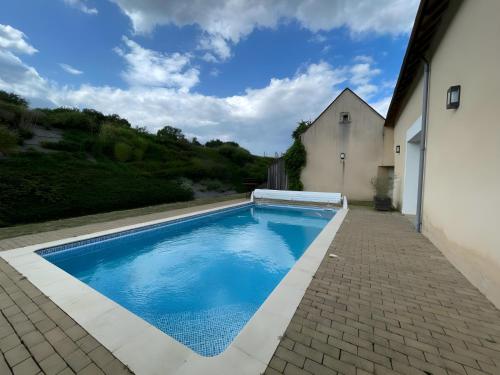 a swimming pool in the backyard of a house at La Grange - Campagne - Piscine 15p - Rêve au Mans in Thorée-les-Pins