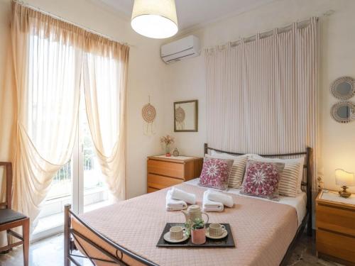 a bedroom with a bed with a tray of food on it at Nonna in Lefkada