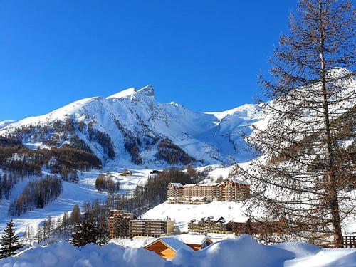 a resort in the snow with a snow covered mountain at Centre station - LA FOUX D'ALLOS - Charmant T2 in La Foux