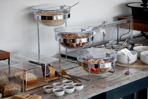 a buffet with bowls of food on a table at Mandilaras Village in Vívlos