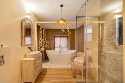 a bathroom with a tub and a sink and a shower at Private Spa in Kangen House Jerez in Jerez de la Frontera