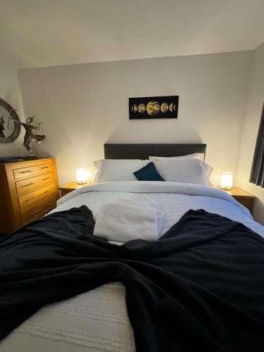 a bedroom with a black blanket on a bed at 1A Priscilla Close in Earlham