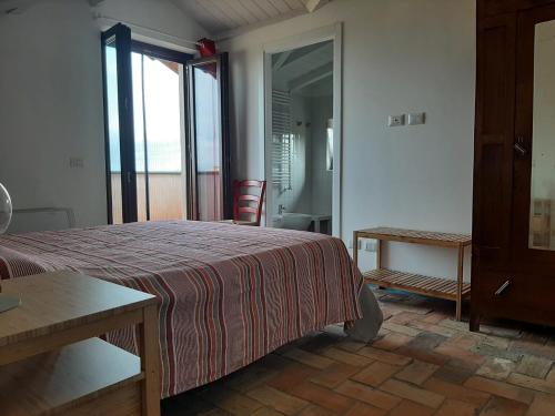 Ένα ή περισσότερα κρεβάτια σε δωμάτιο στο Agriturismo la Romanella