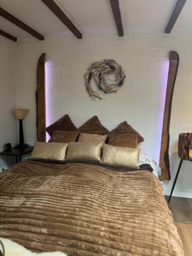 a bedroom with a large bed with a wooden headboard at Cottage 44 - Free parking! in Zandvoort