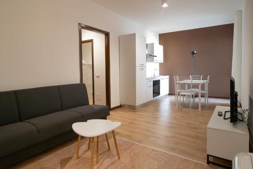 a living room with a couch and a table at Residenza Corso Palladio 159 in Vicenza