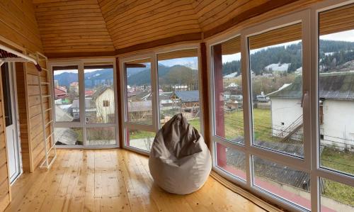 a room with large windows and a large white bean bag at Domashnya Oselya in Verkhovyna