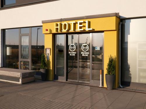 a hotel sign on the front of a building at B&B Hotel Berlin-Airport in Schönefeld