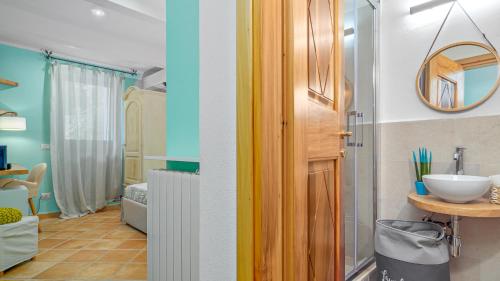 a room with a bathroom with a sink and a mirror at VILLA LA MARINA 5&1, Emma Villas in Porto Cervo