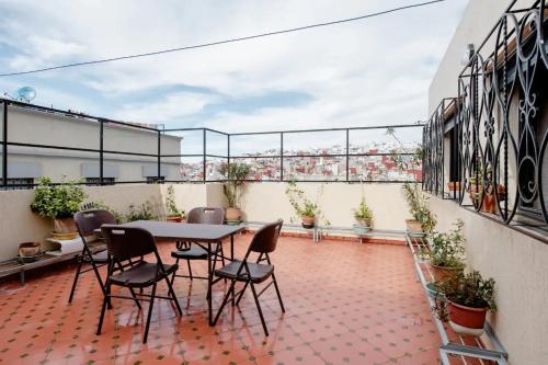 a patio with a table and chairs on a balcony at Studio Rooftop in Tangier