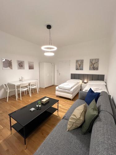 a living room with a couch and a table at Charming Apartment close to Vienna Central Station in Vienna