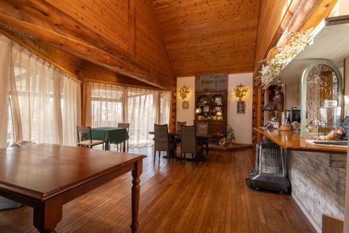 a living room with a table and a fireplace at Secret Heaven in Yamanakako