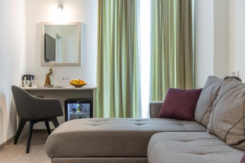 a living room with a couch and a chair at Hotel Fontana Vrnjačka Banja in Vrnjačka Banja