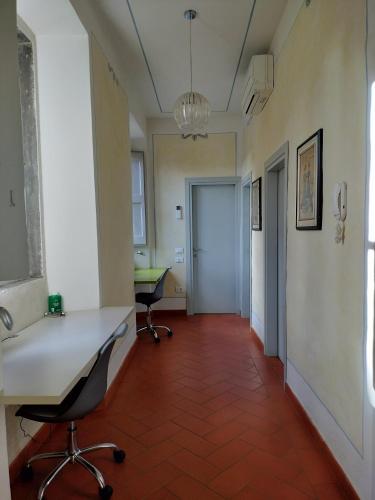 an office with a desk and chairs in a room at Foresteria San Niccolò in Prato