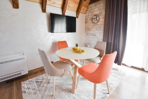 a dining room with a white table and chairs at Lux Villas Zabljak in Žabljak
